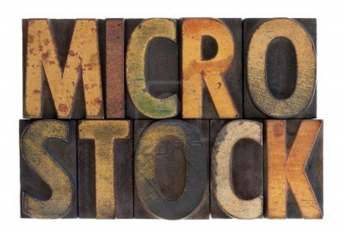 6790061-the-word-microstock-in-vintage-wood-block-type-stained-by-color-ink-isolated-on-white